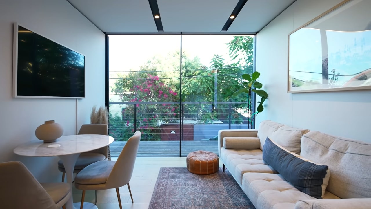 Minimalistic living room with glass door and a TV