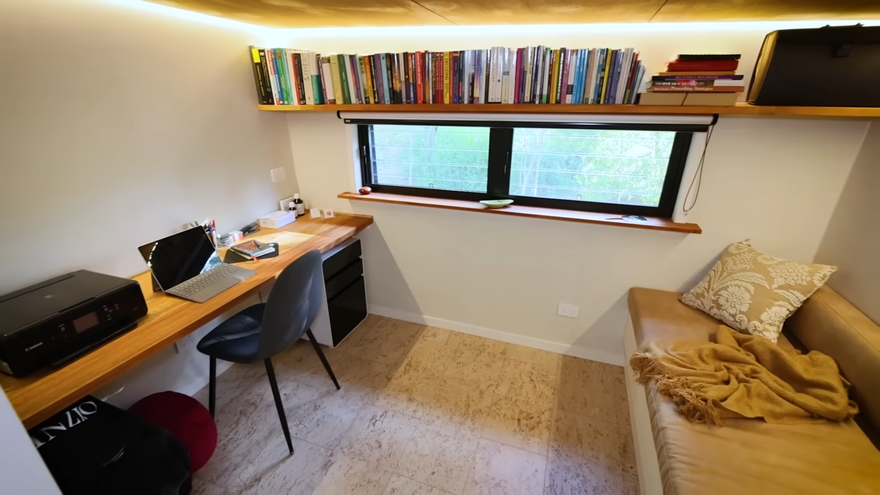 Office with a long table, bench and a bookshelf