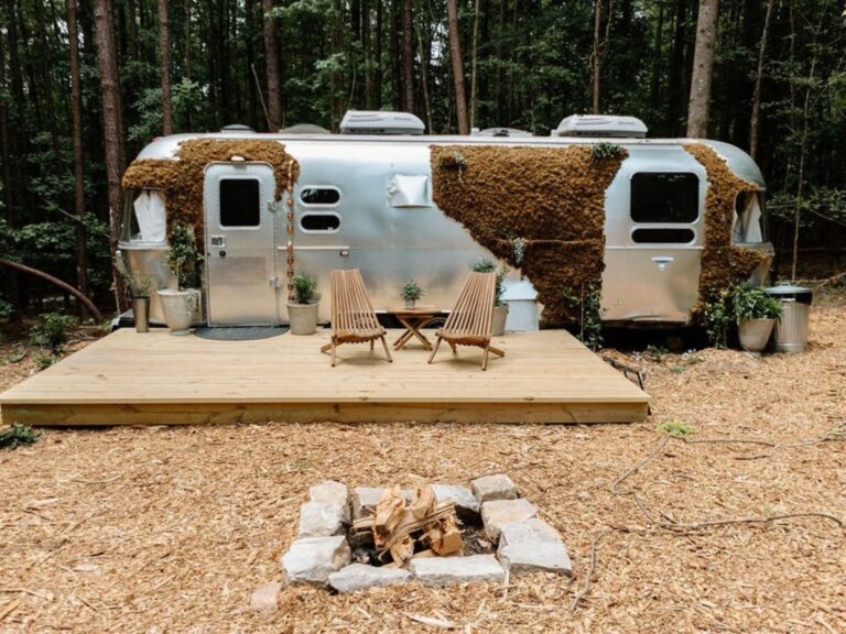 exterior of an airstream with the patio in the woods