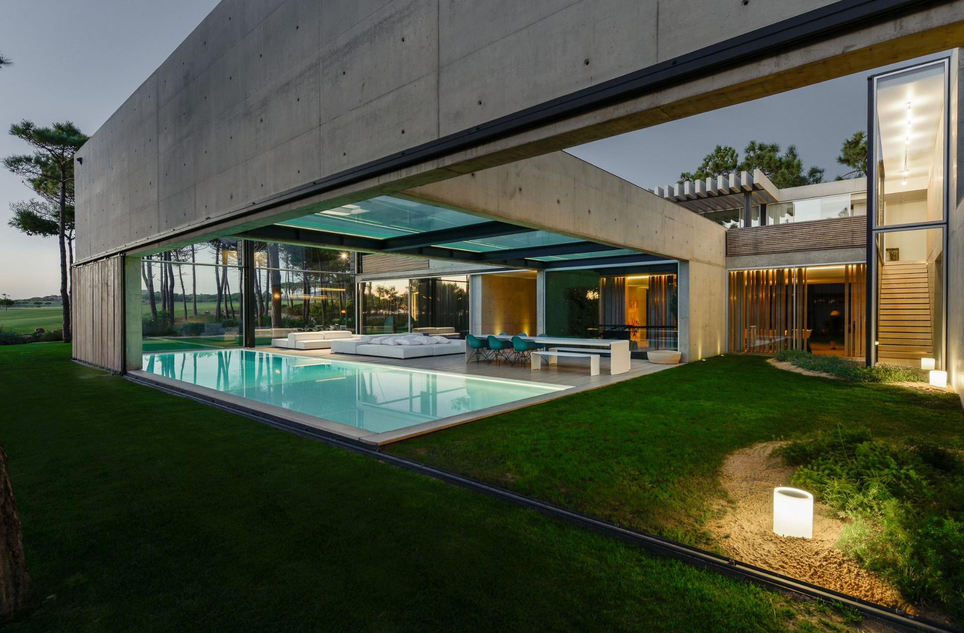 Concrete home with a glass pool on the second floor