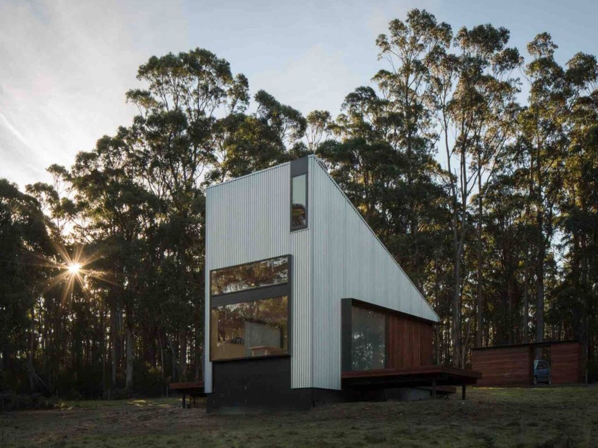 White minimalistic cabin in woods