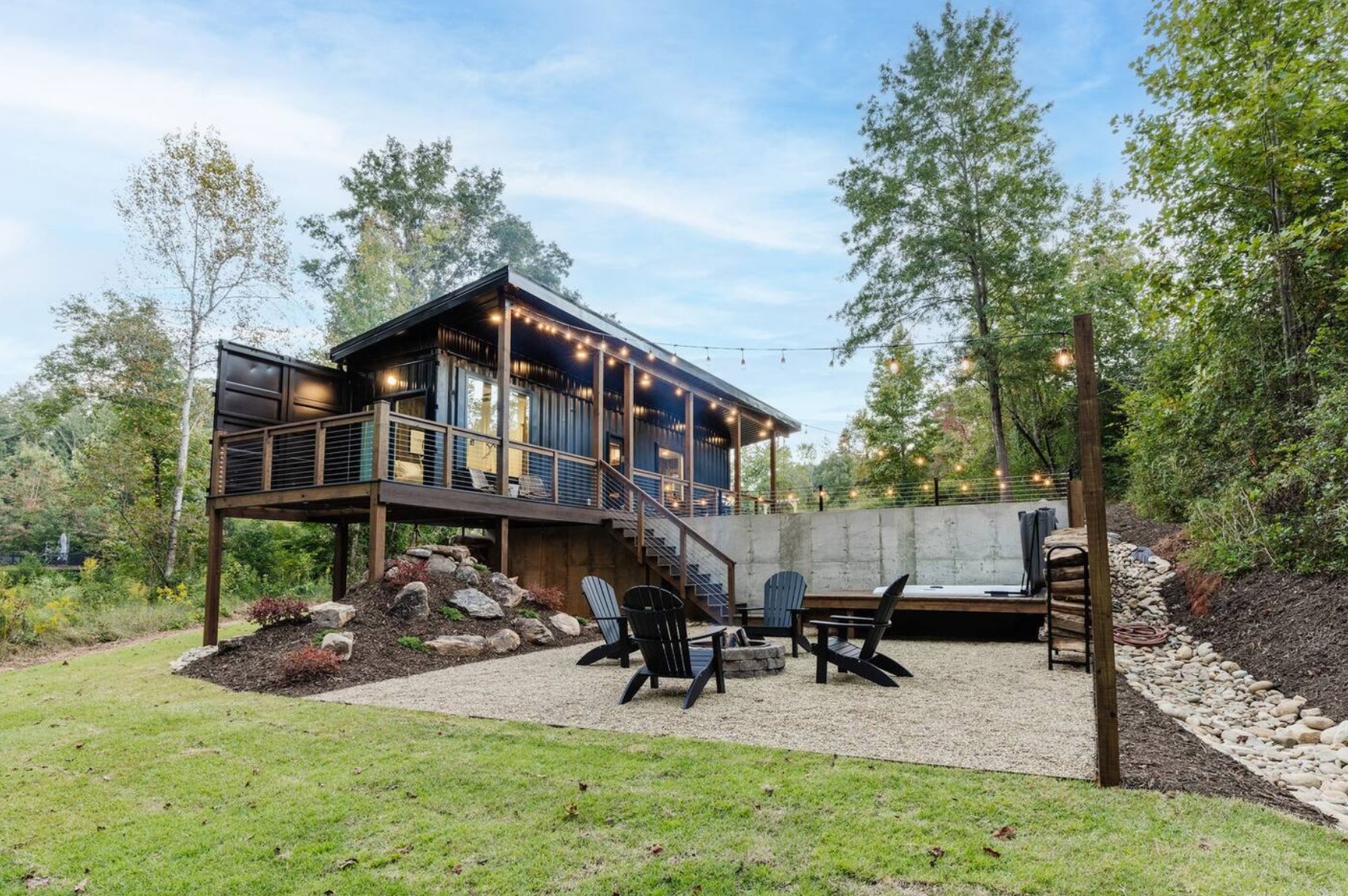 Elevated shipping container cabin with fire pit