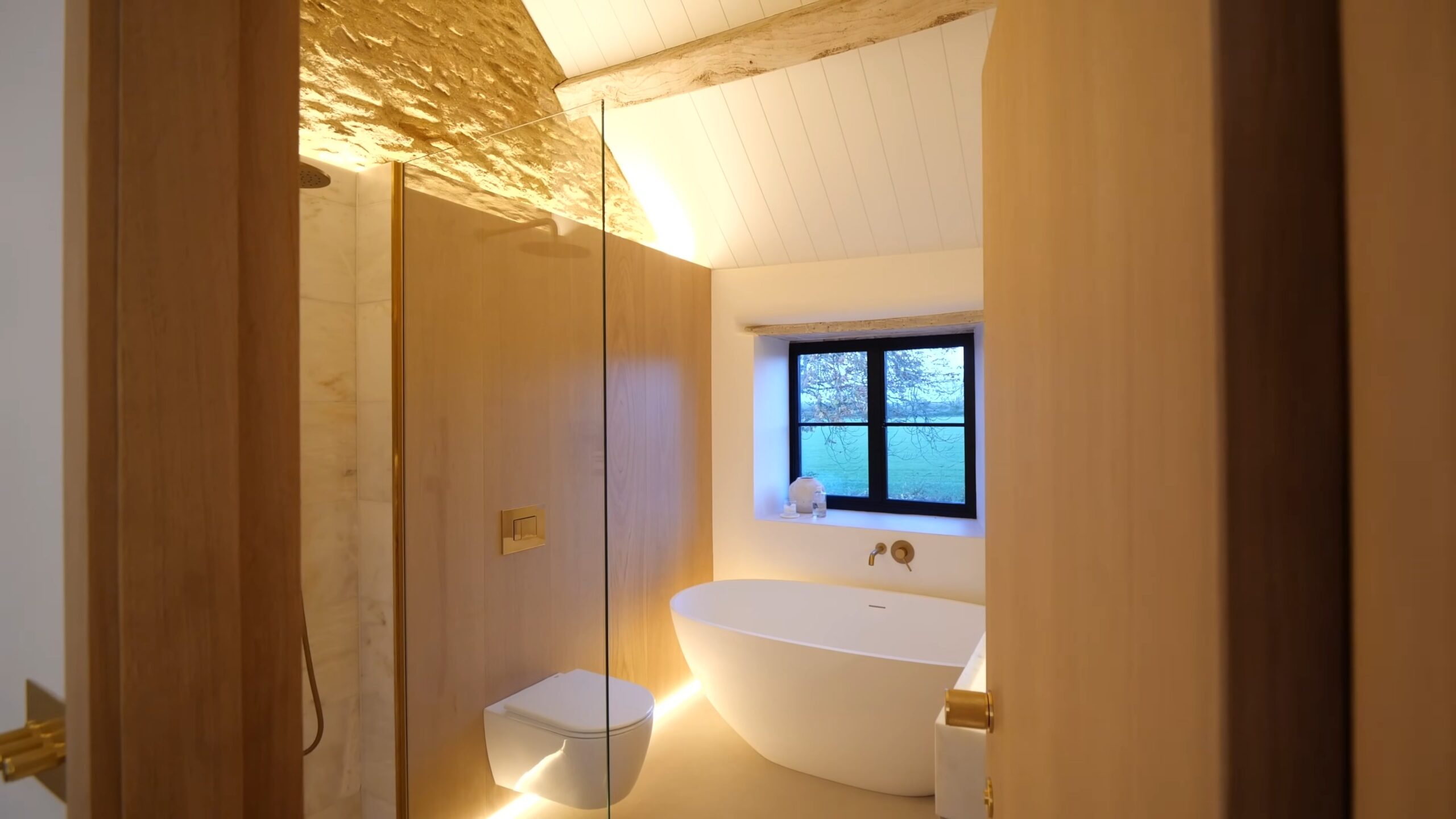 bathroom with stone and wood decor, lit up with LED lights