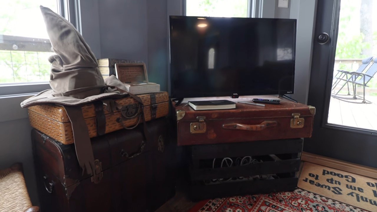 TV standing on stacked suitcases with Harry Potter decorations