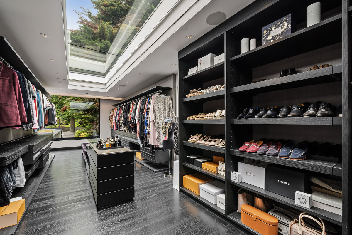 Walk-in closet with black floors and a skylight