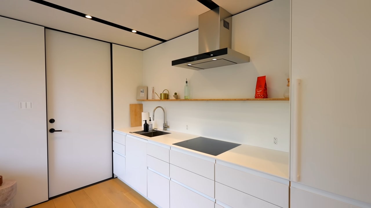 White minimalistic kitchen with gray range hood