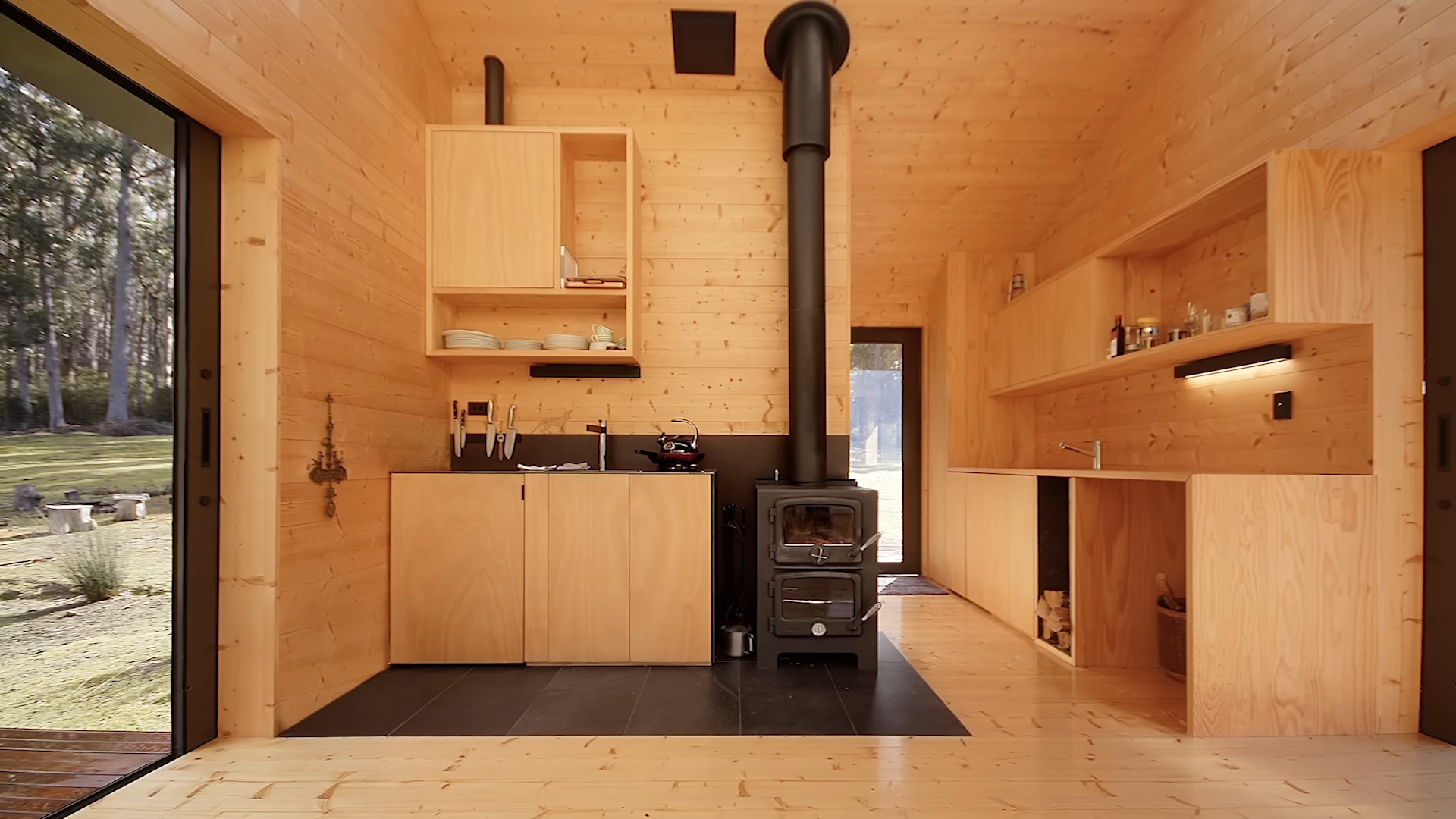 Wooden minimalistic kitchen with a smile fireplace and tons of storage