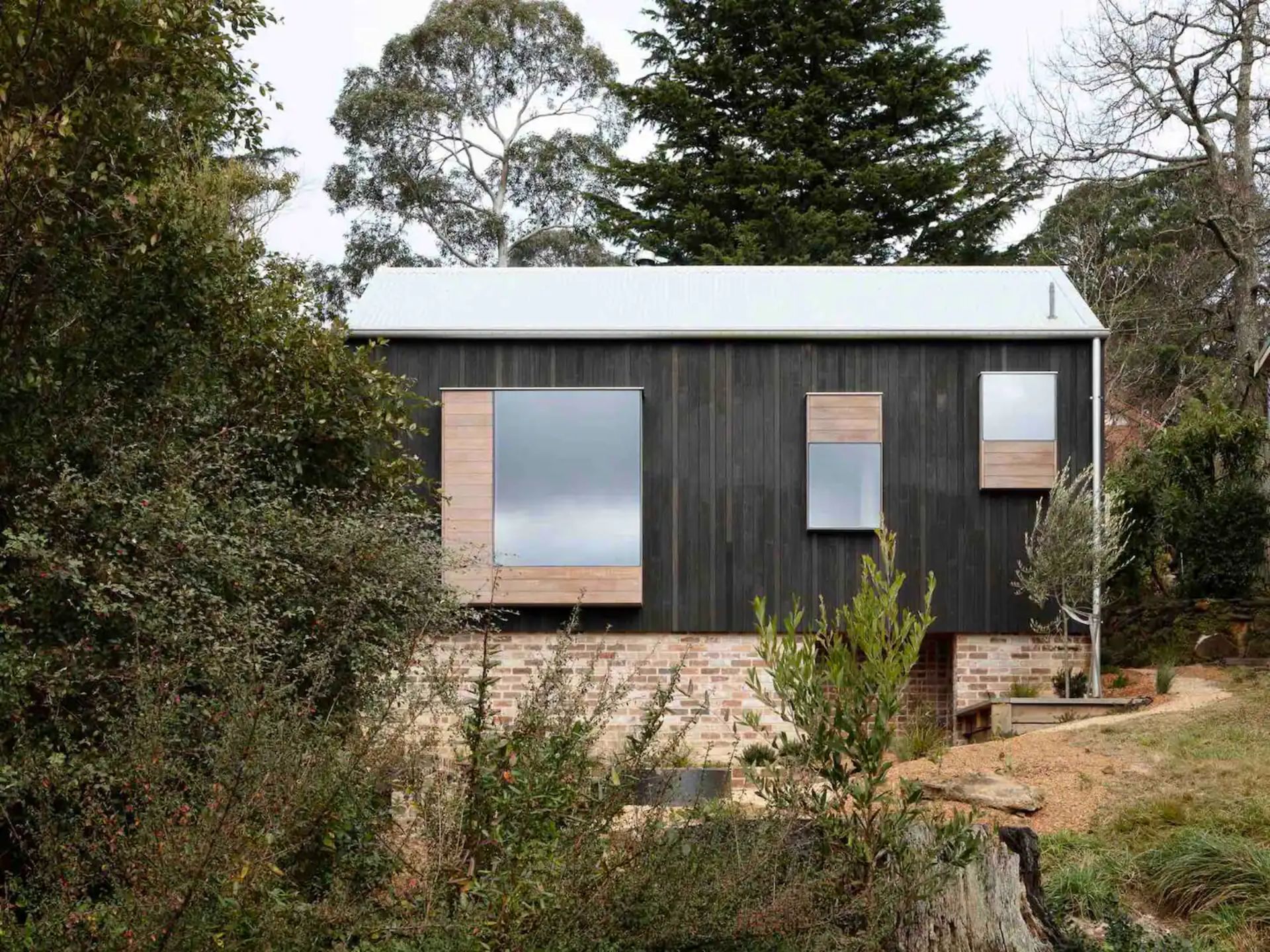 Little black cabin with big windows