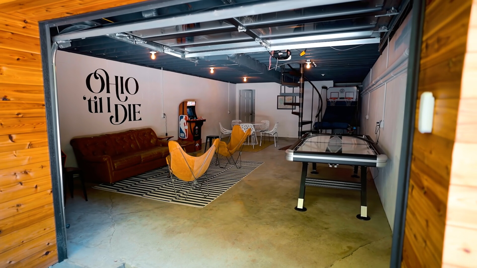 basement with games, yellow picnic chairs and a brown couch