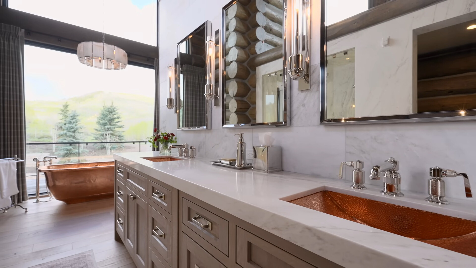 bathroom with a copper bathtub and copper sinks