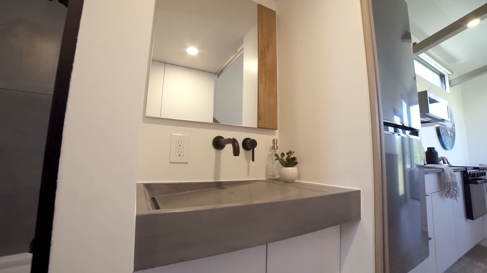 bathroom with a gray sink and a big mirror