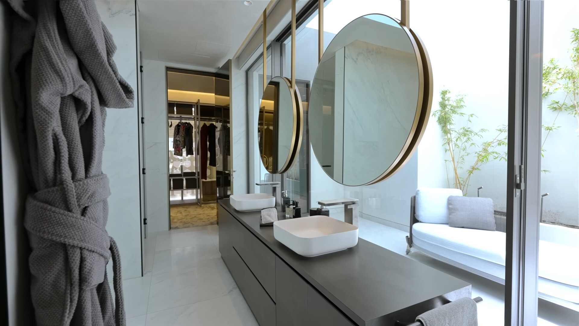 bathroom with two white sinks and two mirrors