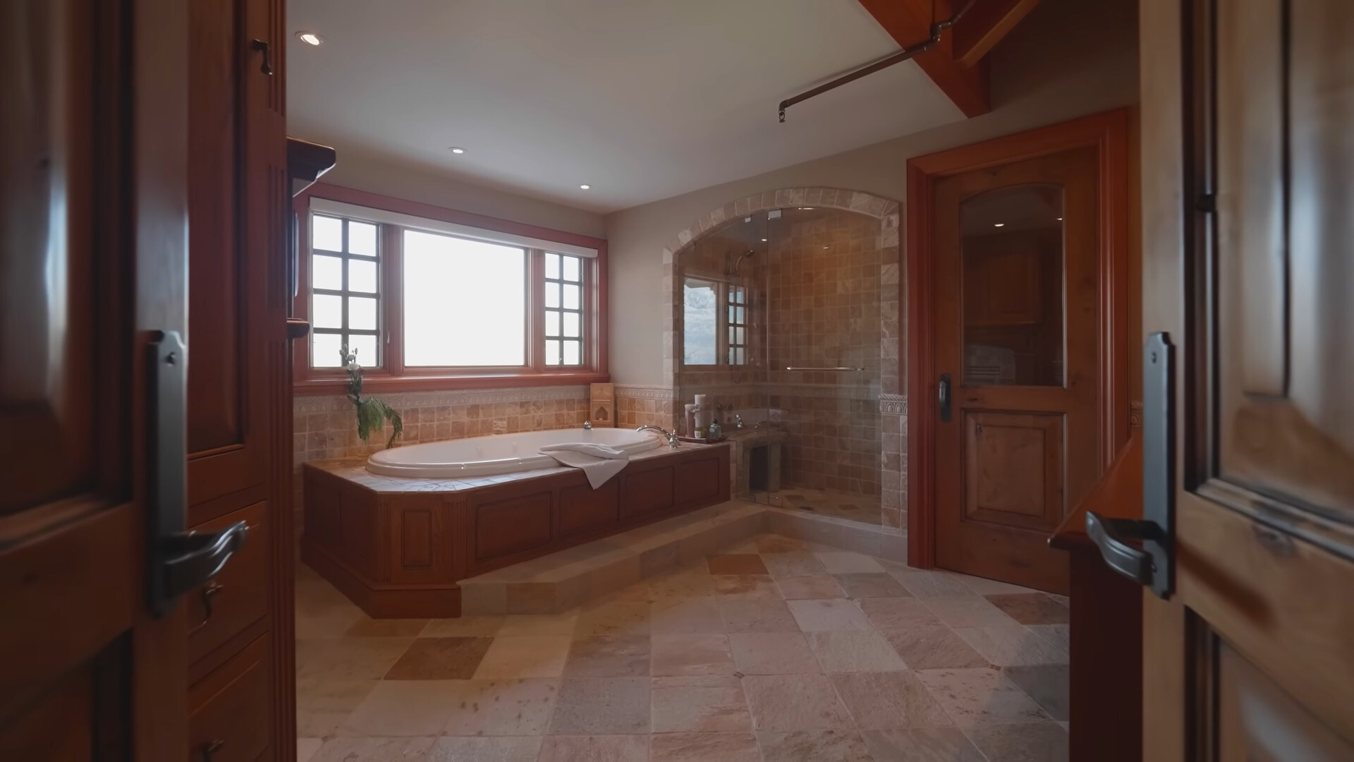 bathroom with a white bathtub and a glass shower