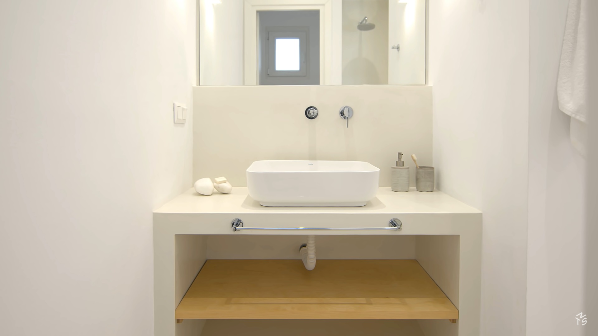 bathroom with a white sink and a mirror above and a white countertop