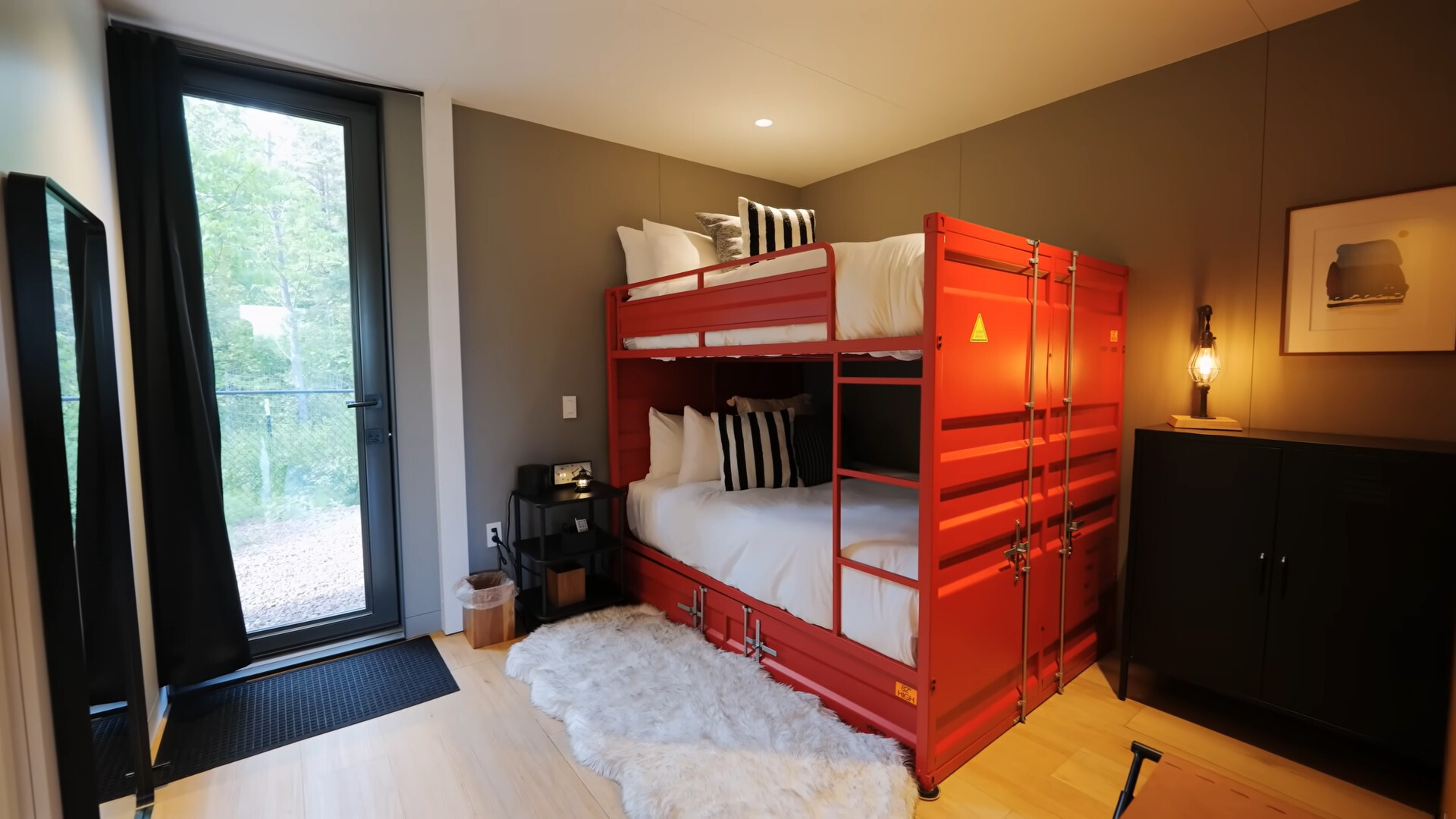 bedroom with a container bunk bed and glass doors