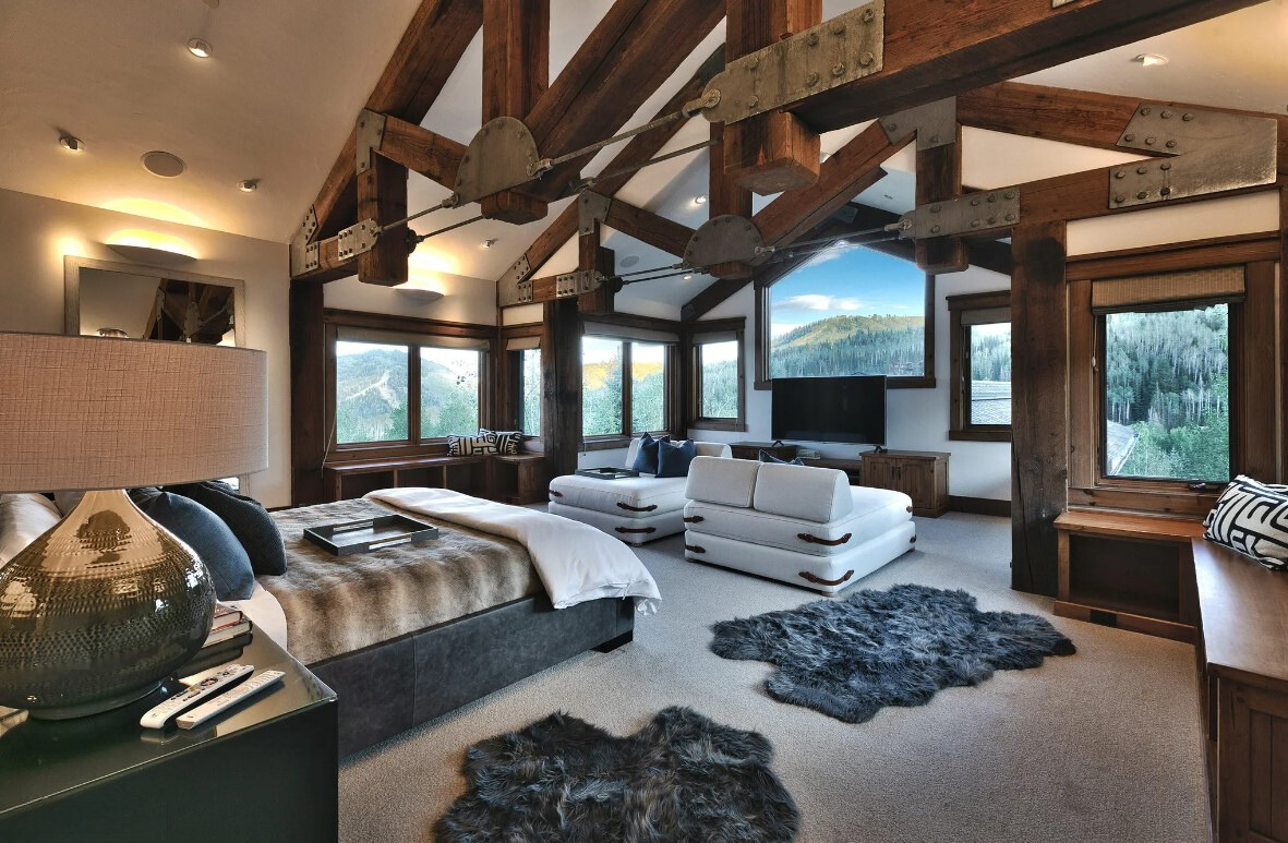 bedroom with a comfy couch and a lot of windows with views of nature