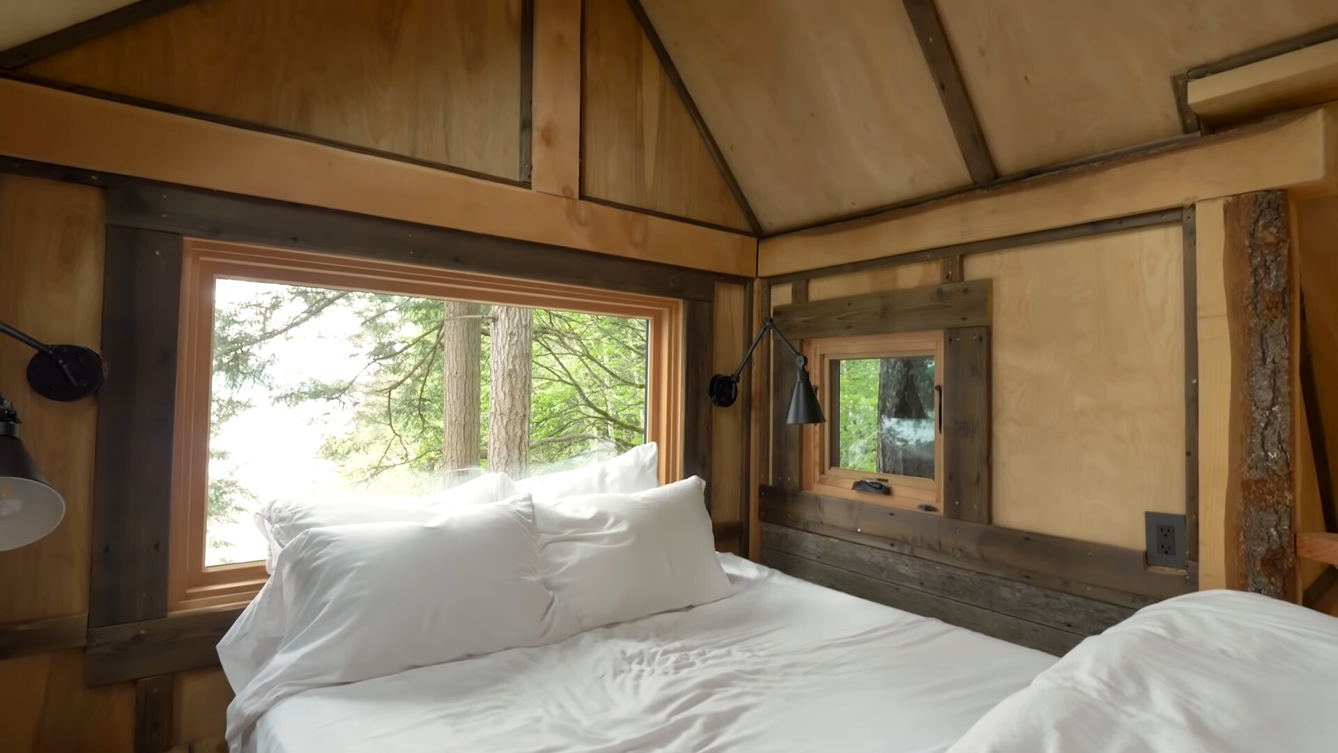 loft bedroom with windows around it