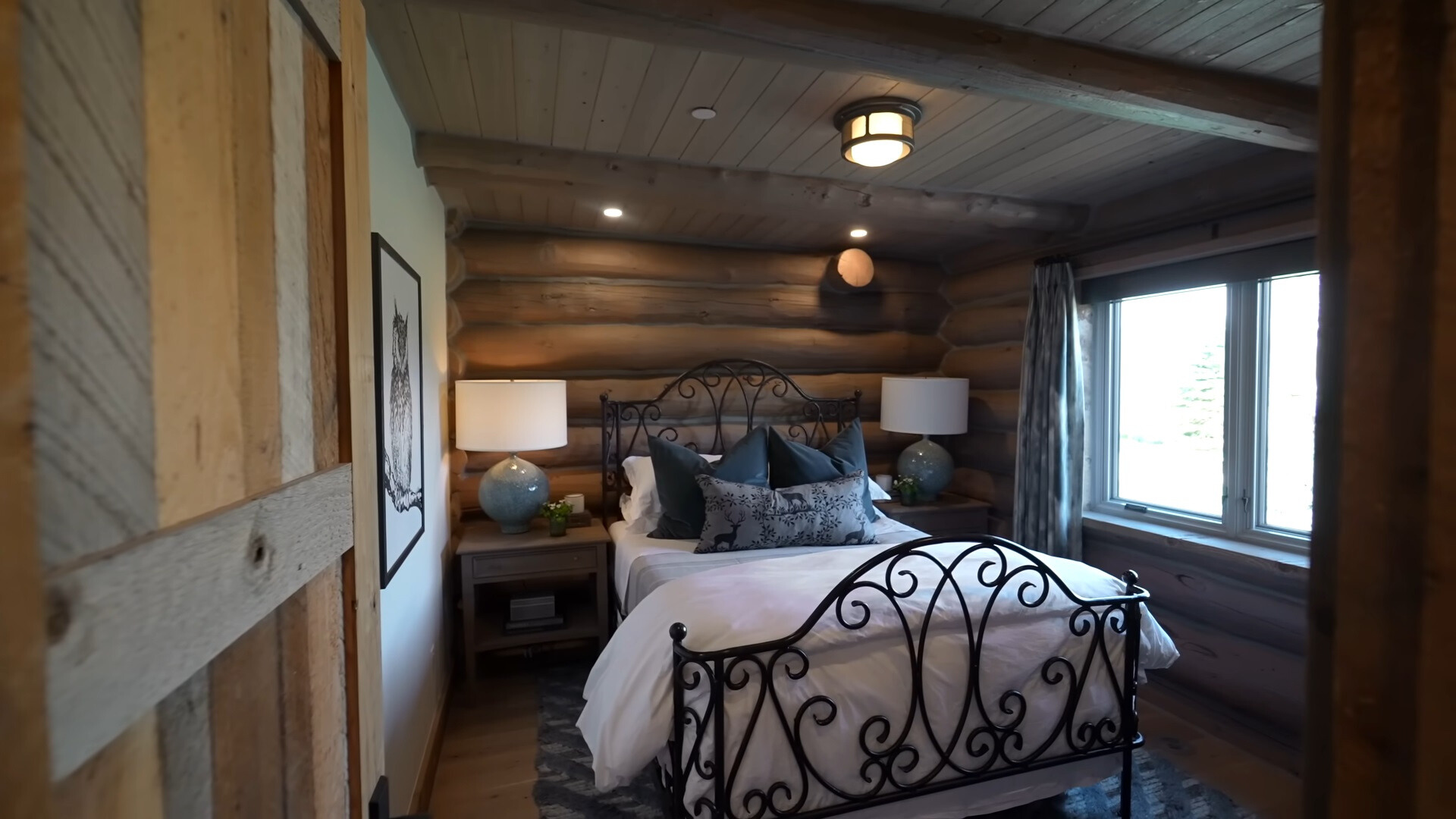 bedroom with one wooden wall and wooden ceiling