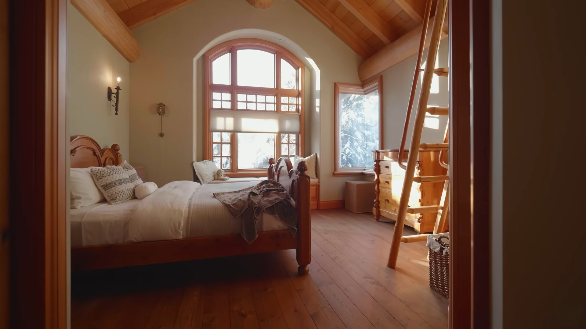 bedroom with two beds and a ladder leading up to a loft