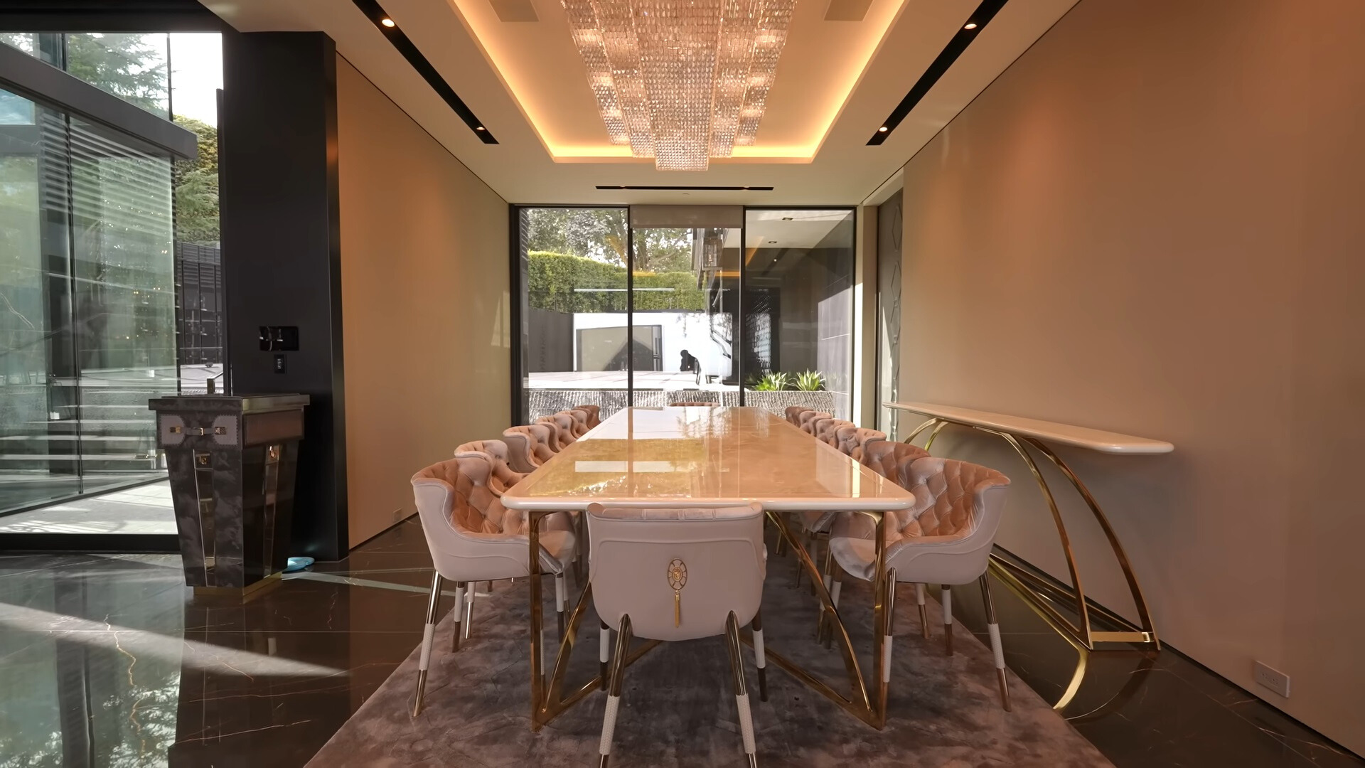 big, white dining table and light pink chairs