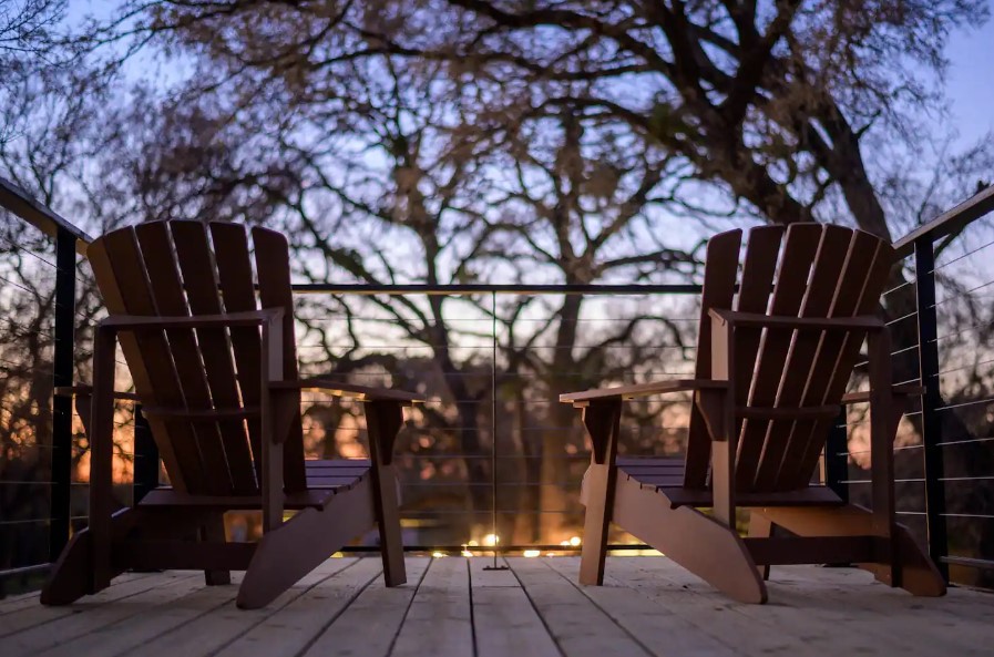 brown chairs on the rooftop of a container house