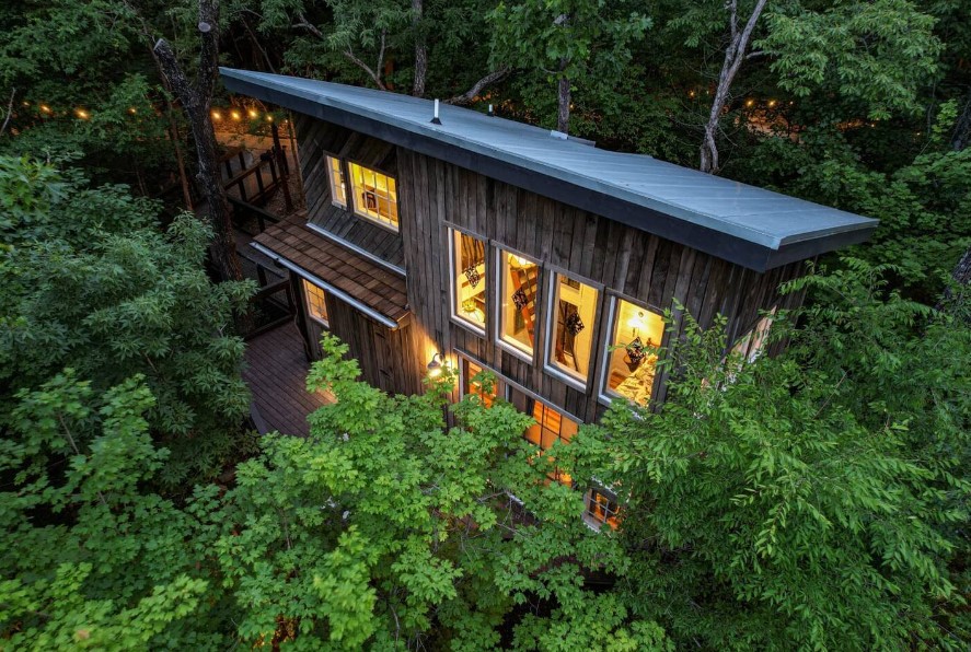 mixture of a rustic and modern treehouse in the woods