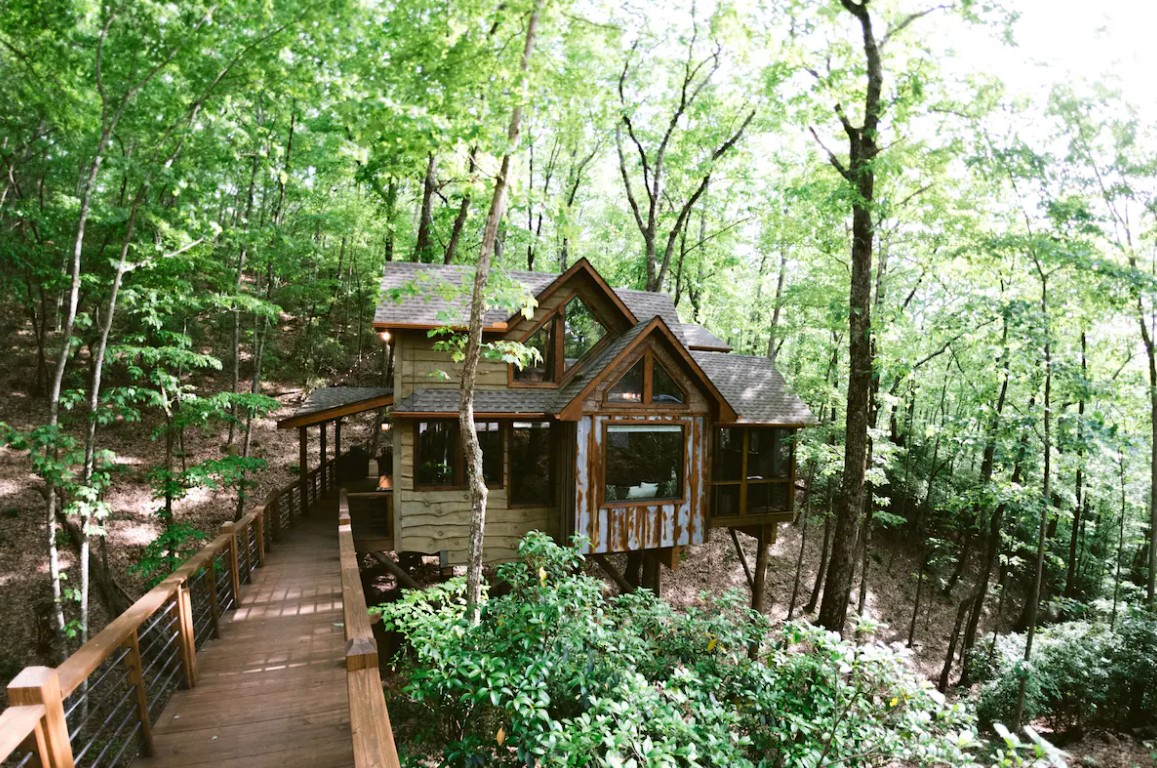 treehouse with a little bridge in the woods