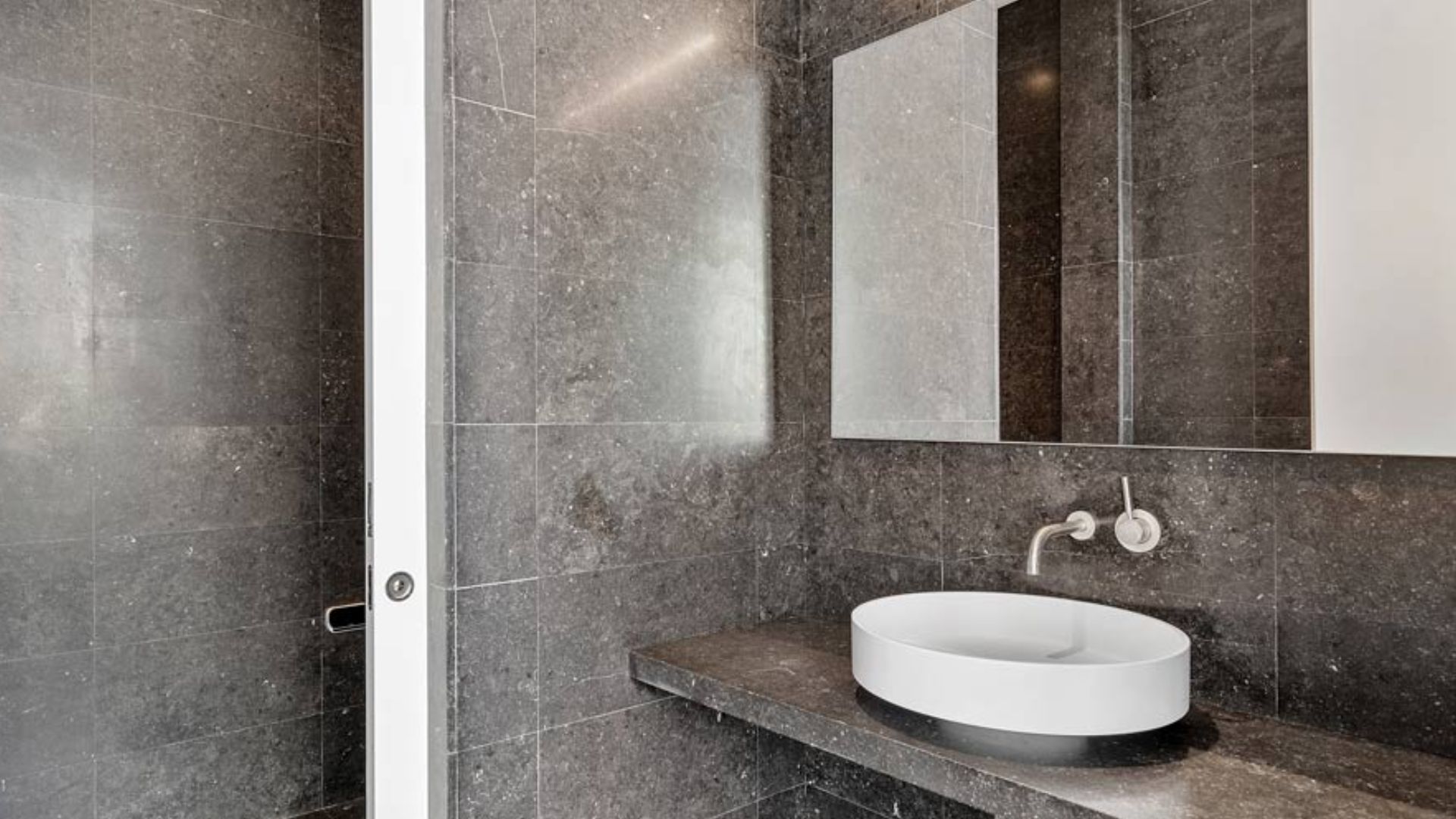 cool round sink in a grey bathroom