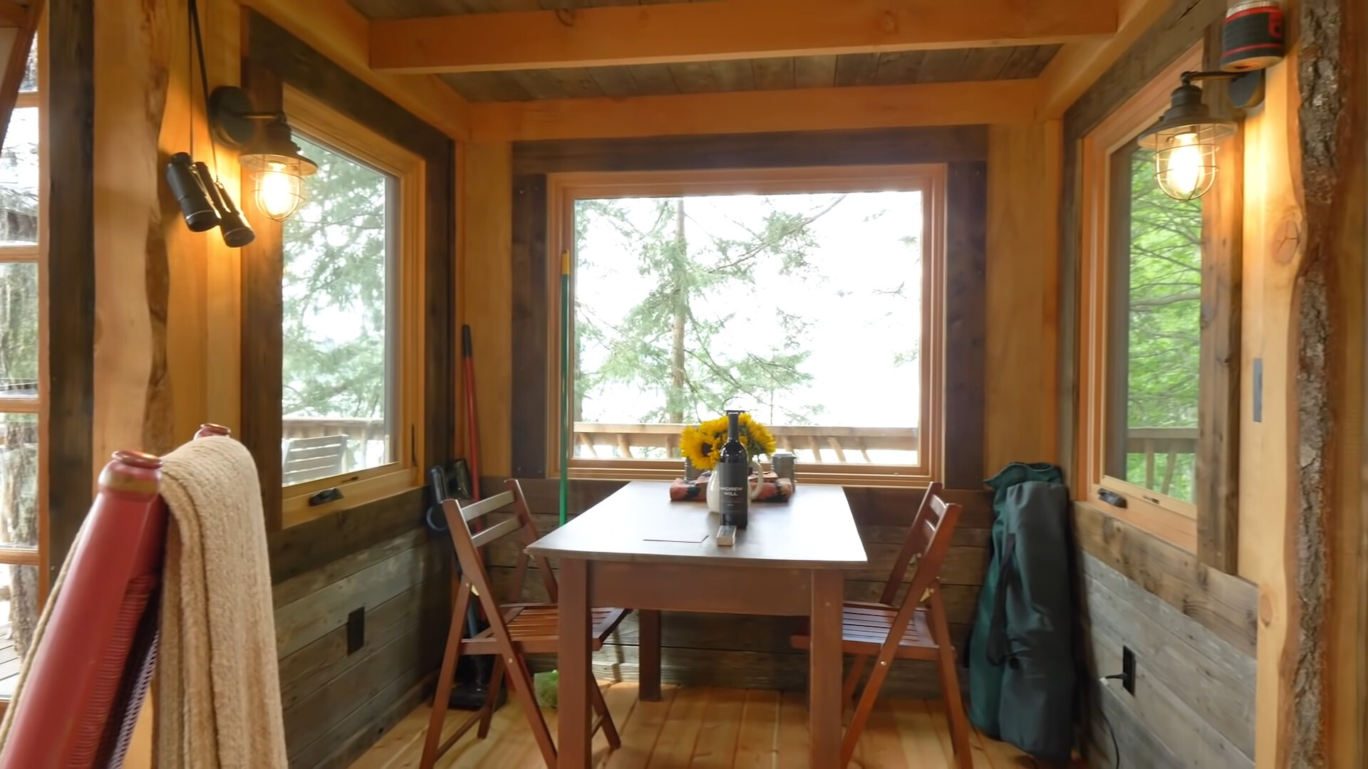 dining room with a brown dining table and two chairs and windows all around