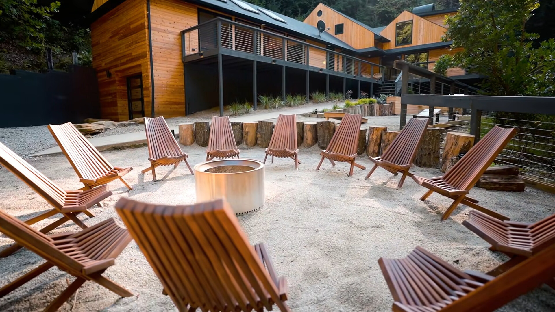 firepit surrounded by brown, wooden chairs