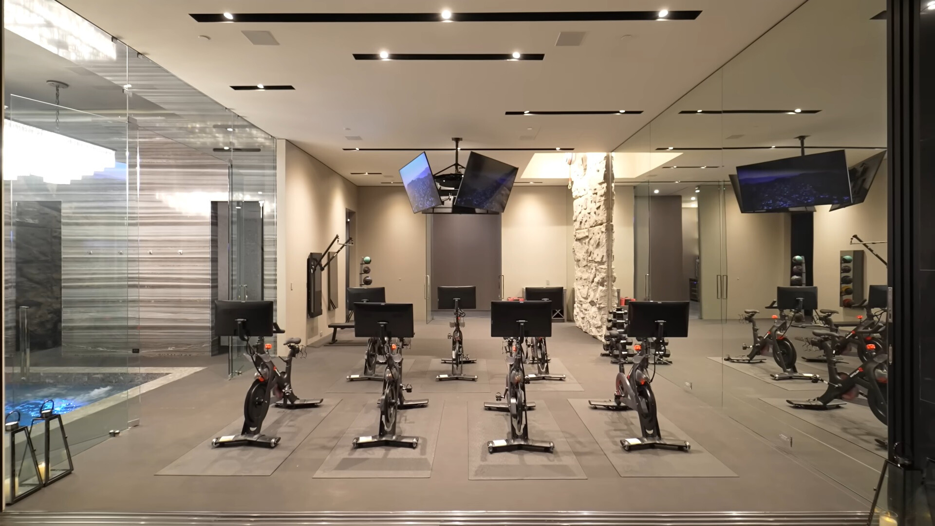 private gym of a modern house with flat screen tvs