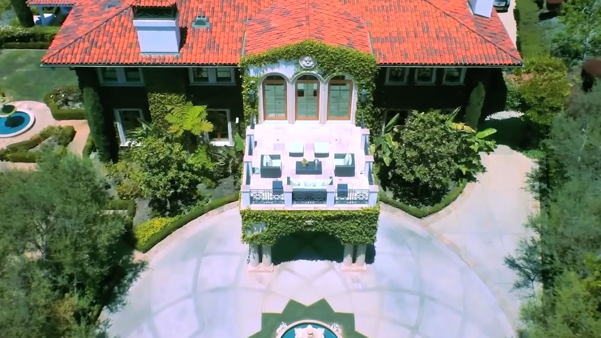 heidi klum and seal house with a round roof, a terrace, and a rounded driveway