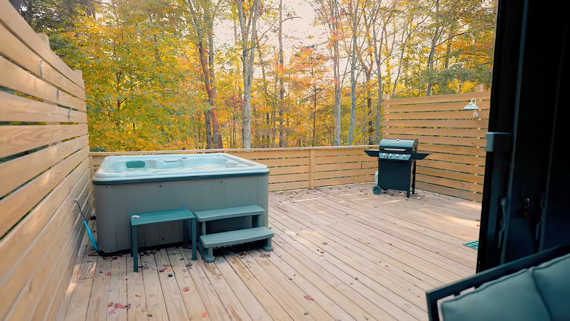 hot tub and a grill outside of the house