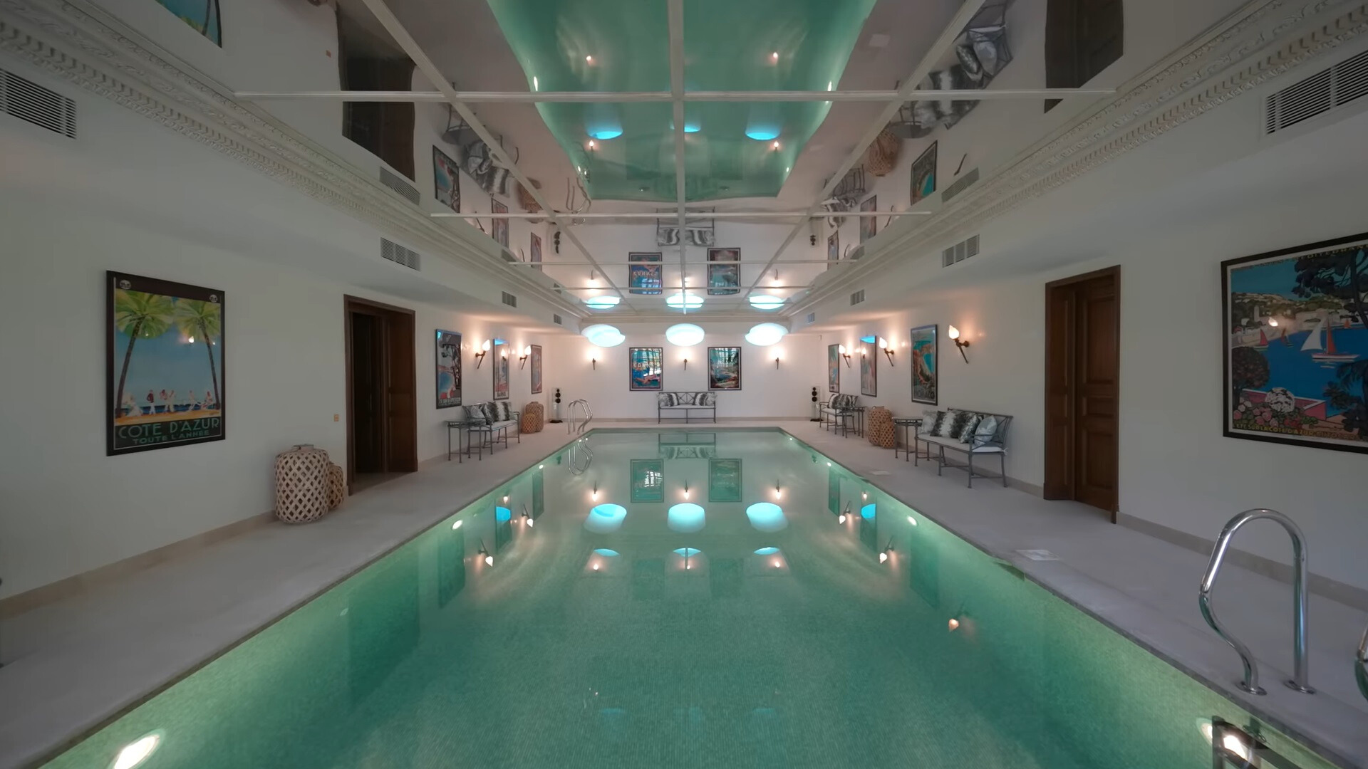 indoors pool with seating areas around it