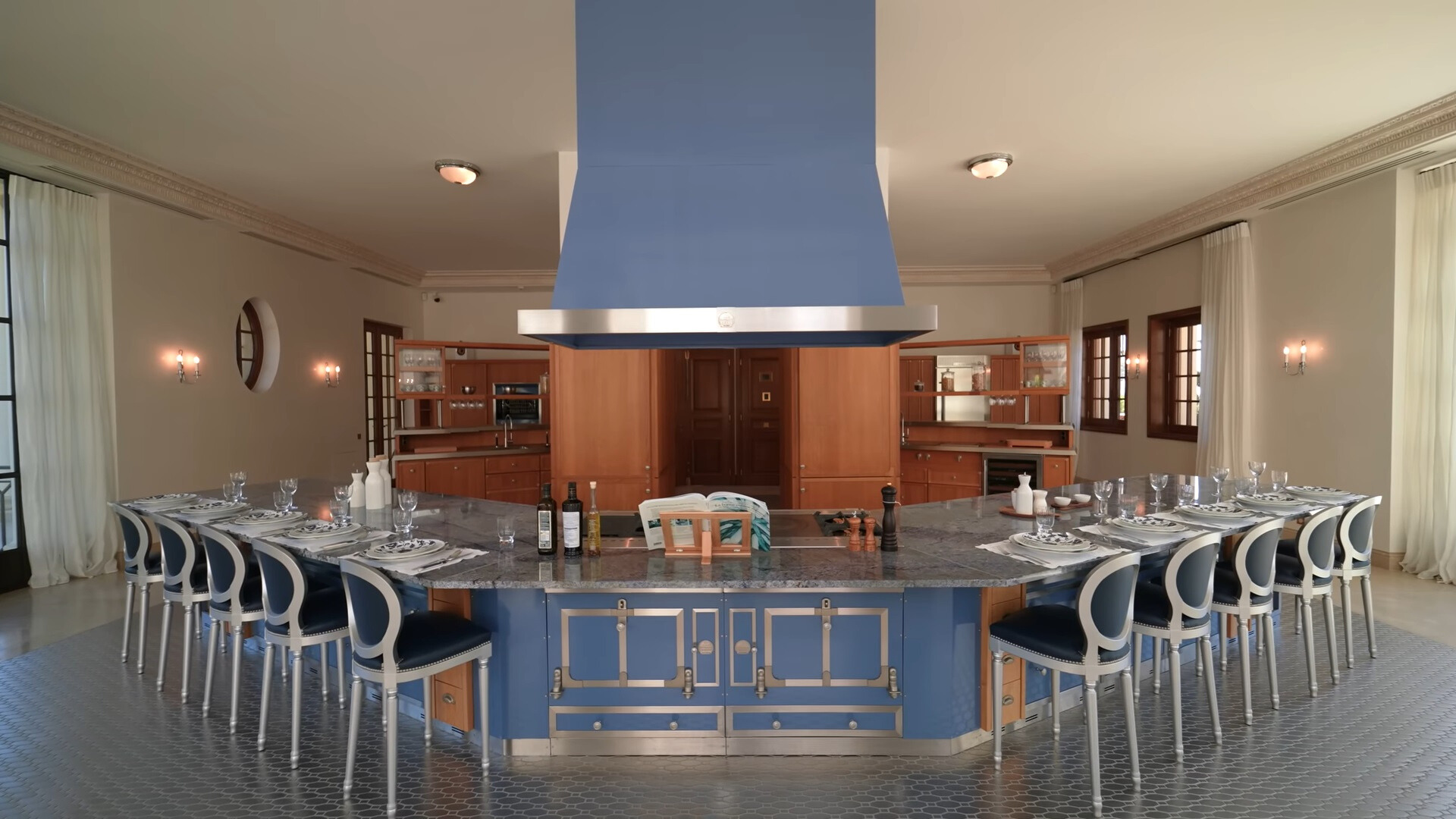 kitchen with blue cabinets and gray countertop and silver and blue chairs