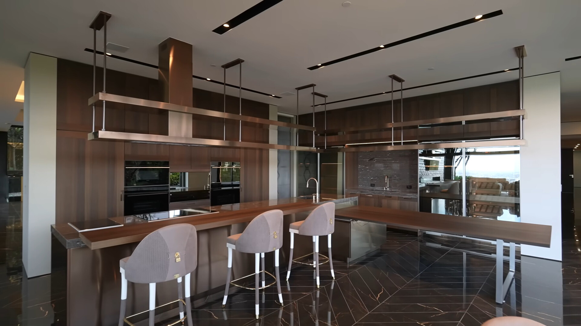 kitchen with brown countertops, gray chairs and brown cabinets