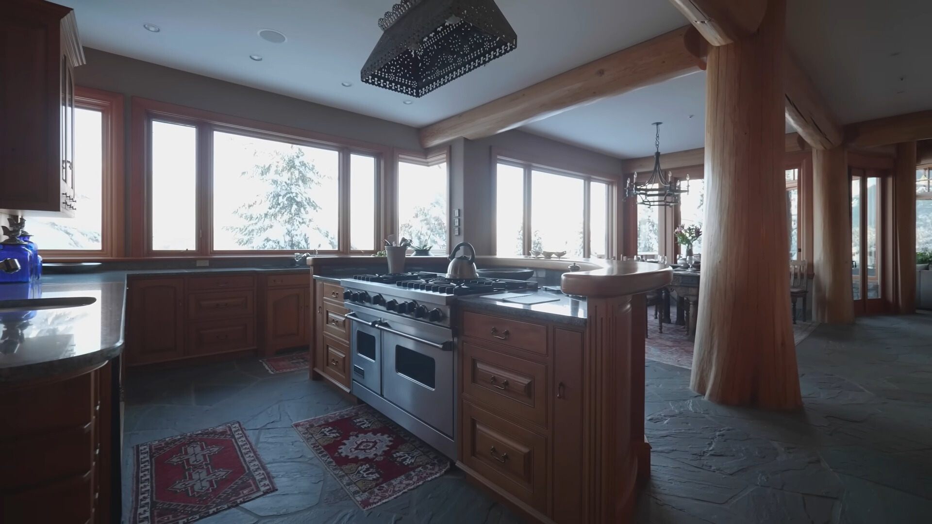 kitchen with brown cabinets, many windows, half round bar table