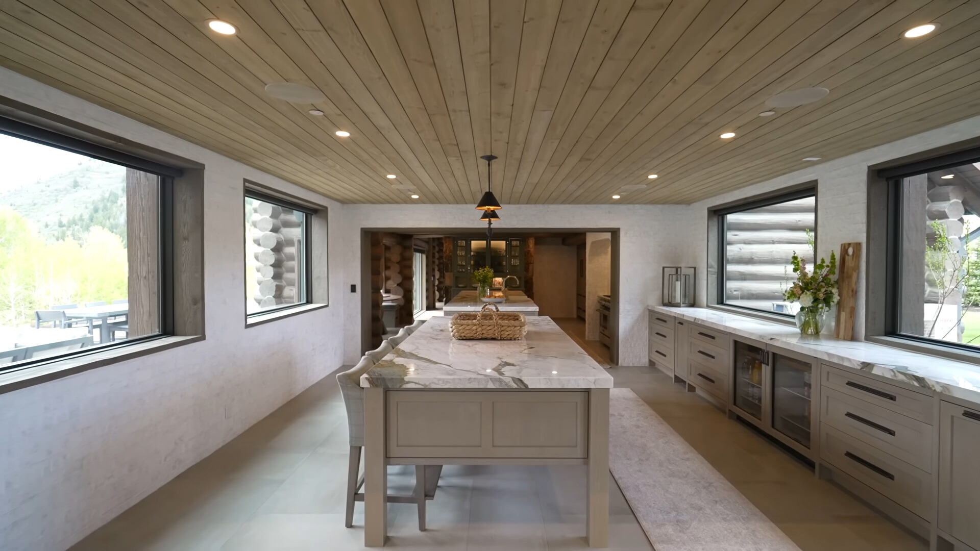 kitchen with windows on both sides, gray cabinets and dolomite stone countertops and an island in the middle