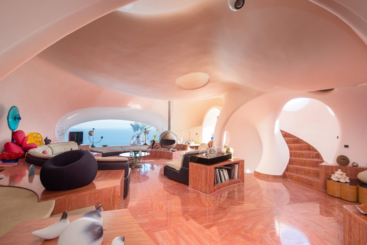 living room with light pink walls and an ocean view