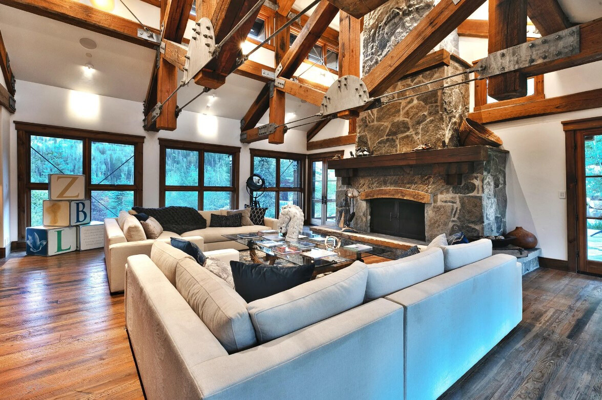 living room with a white couch and big windows and a fireplace