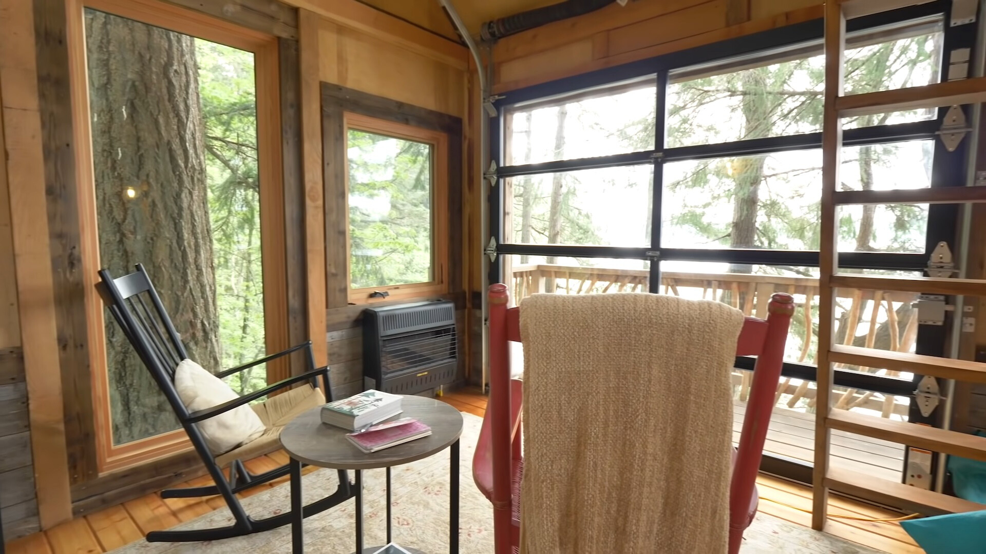 living room with two rocking chairs, tiny round table and floor to ceiling windows