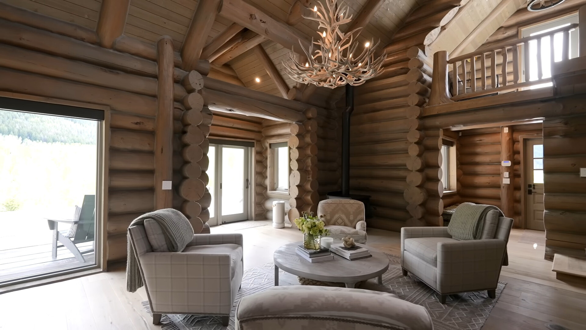 living room with four gray sofas and a wooden chandelier