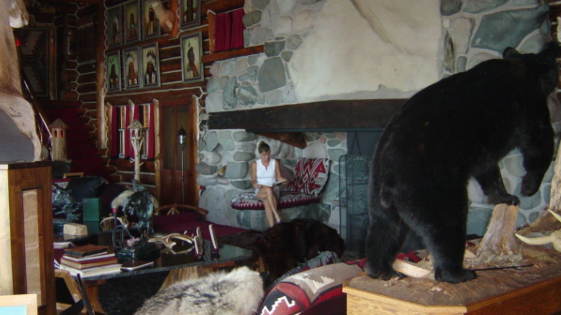 massive fireplace of the granot loma with stone finishes, taxidermy animals all over the room