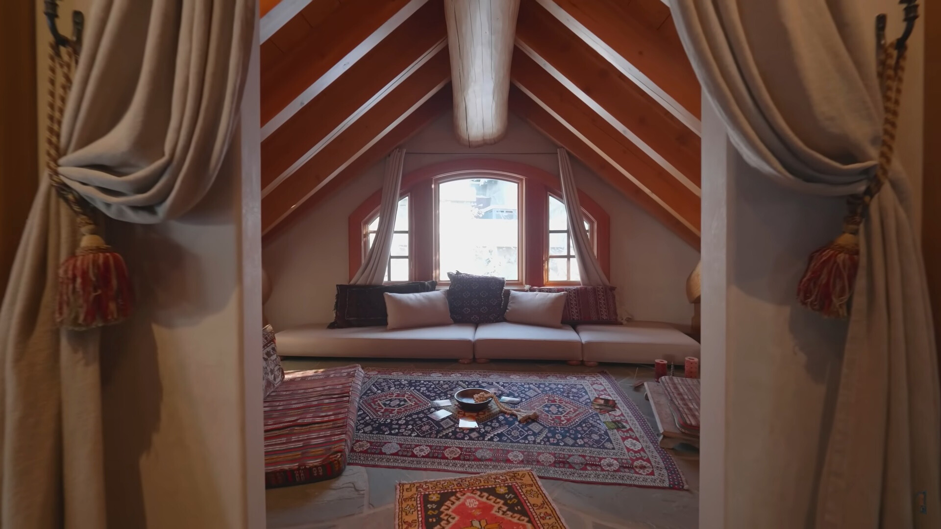 meditation room with colorful carpets, sitting area, tarot cards