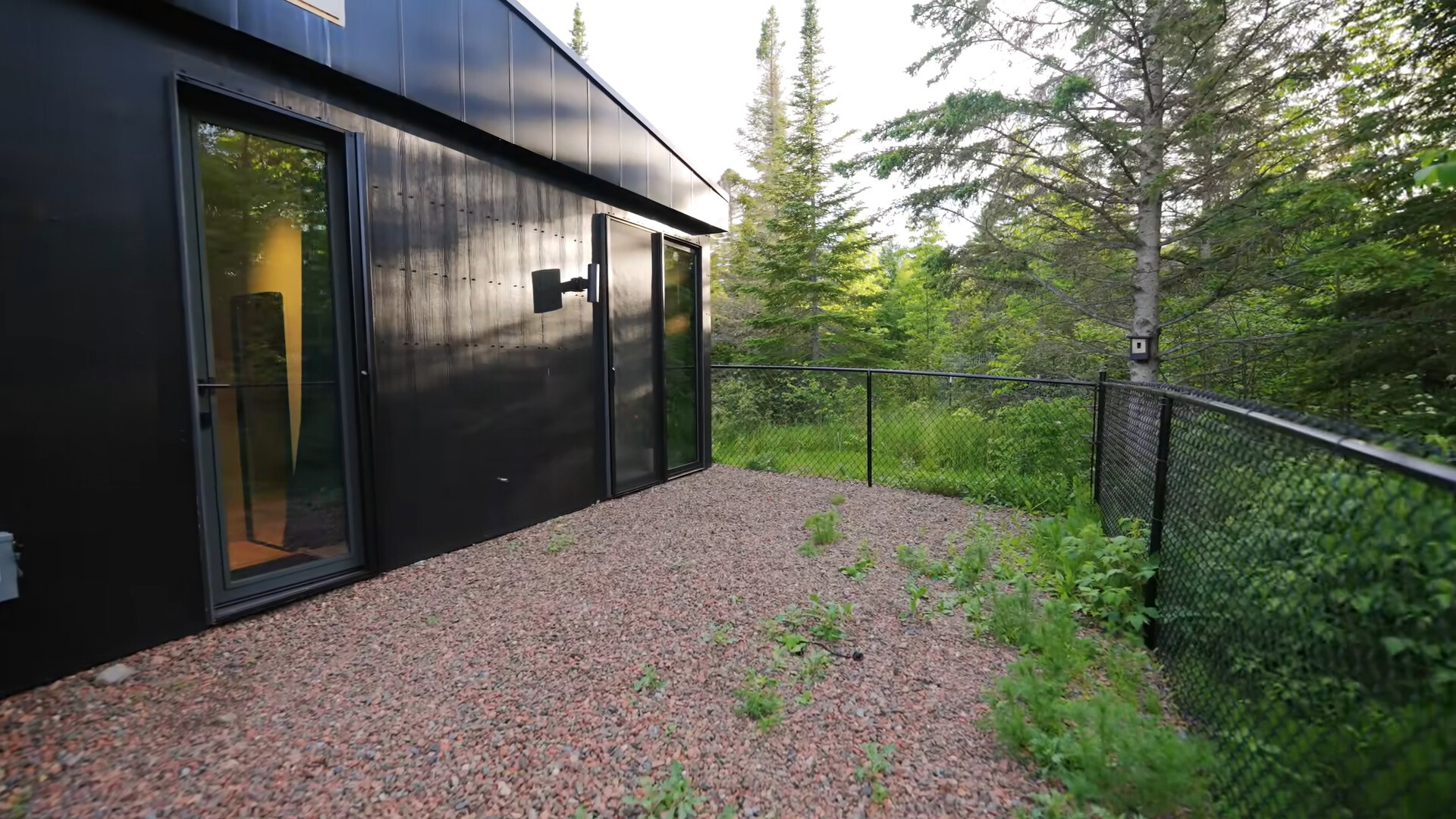 outside area of a container house surrounded by a fence