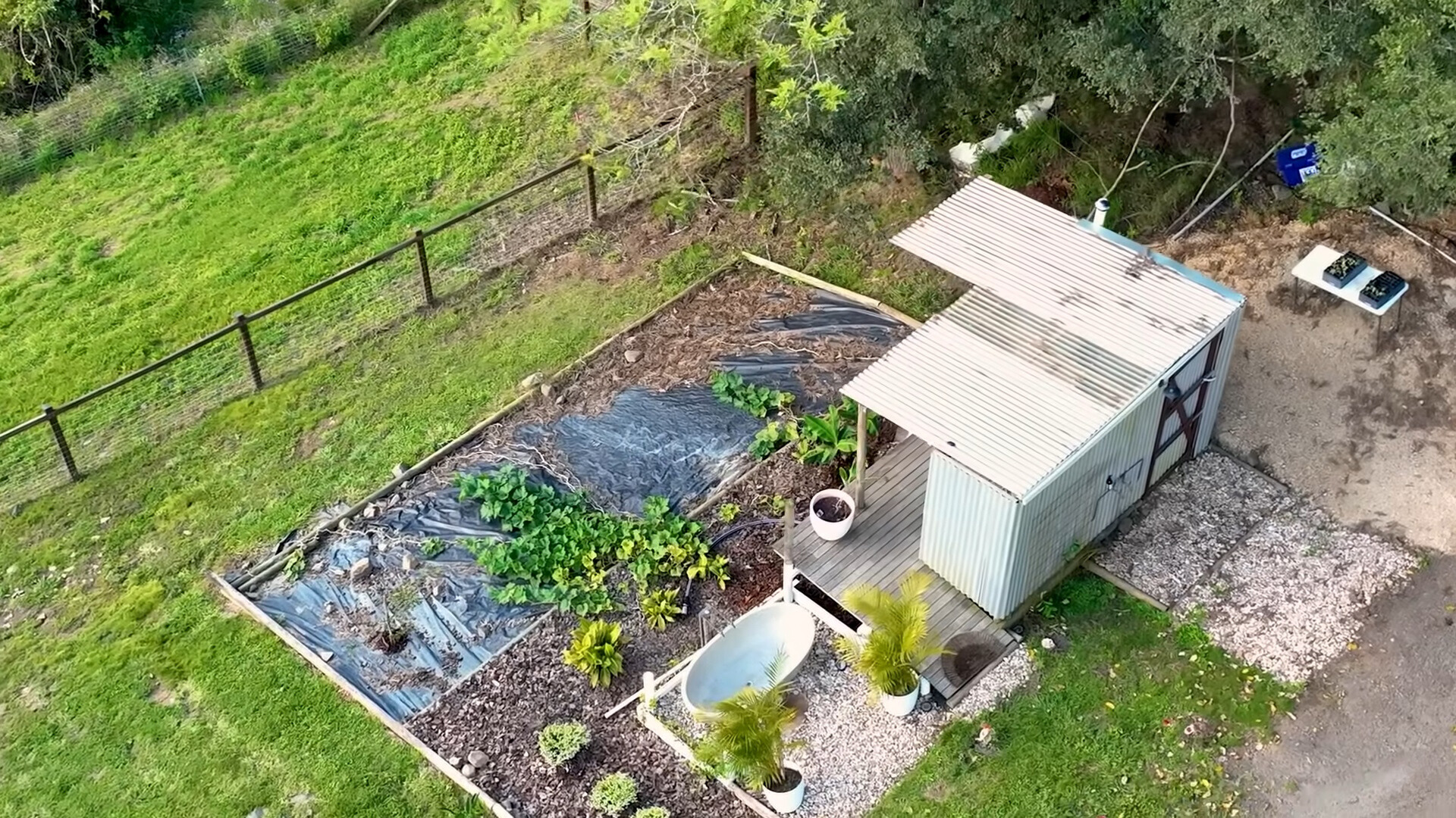 outside white bath tub and a garden around it