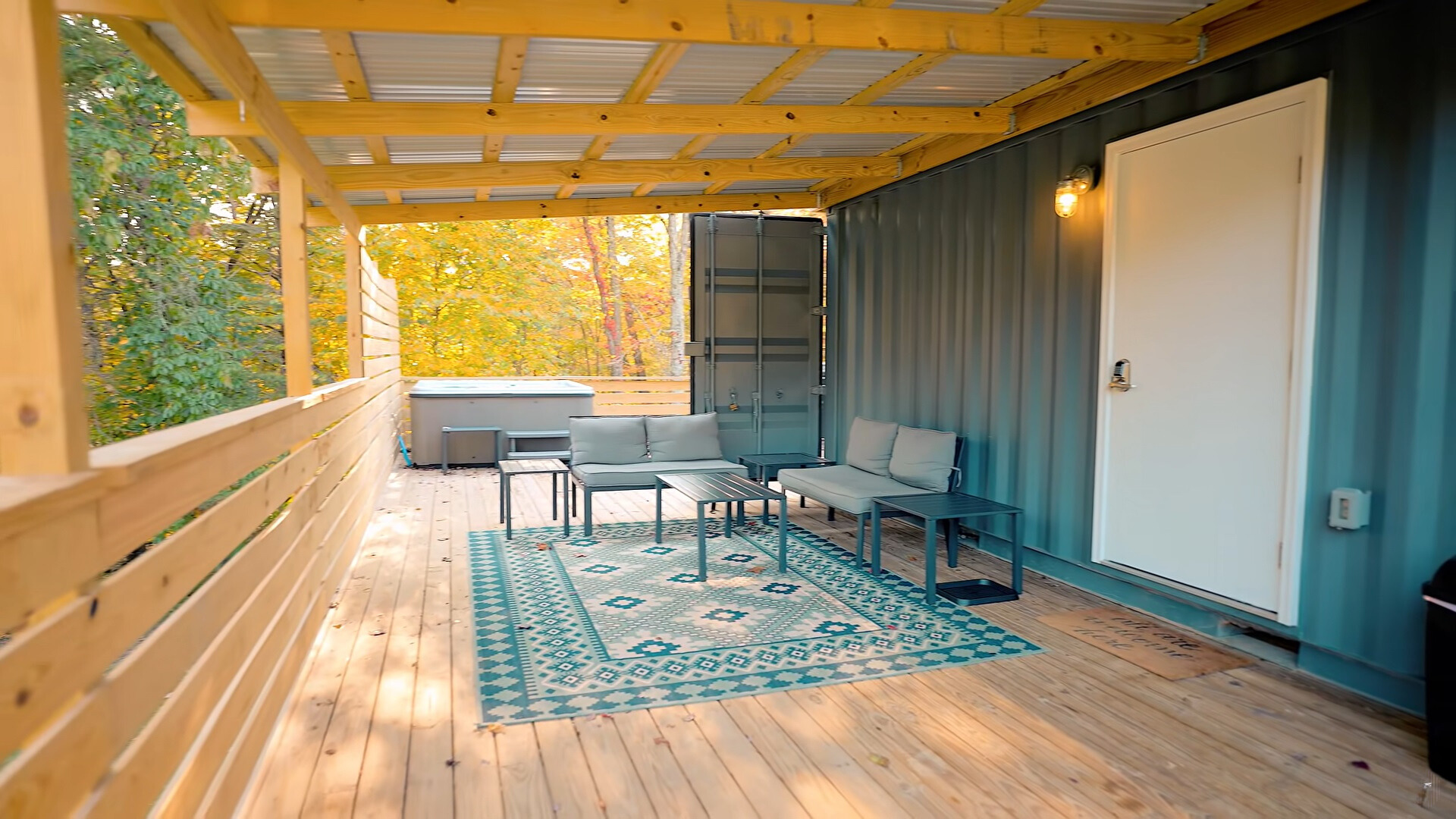 outside deck with a small table and a cushioned sitting area and a carpet