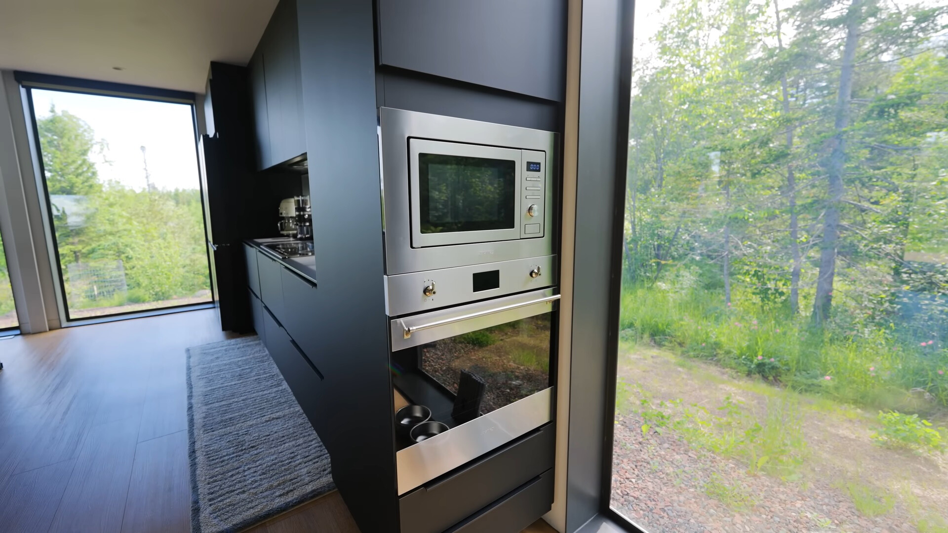 oven and microwave on the side of a black cabinet