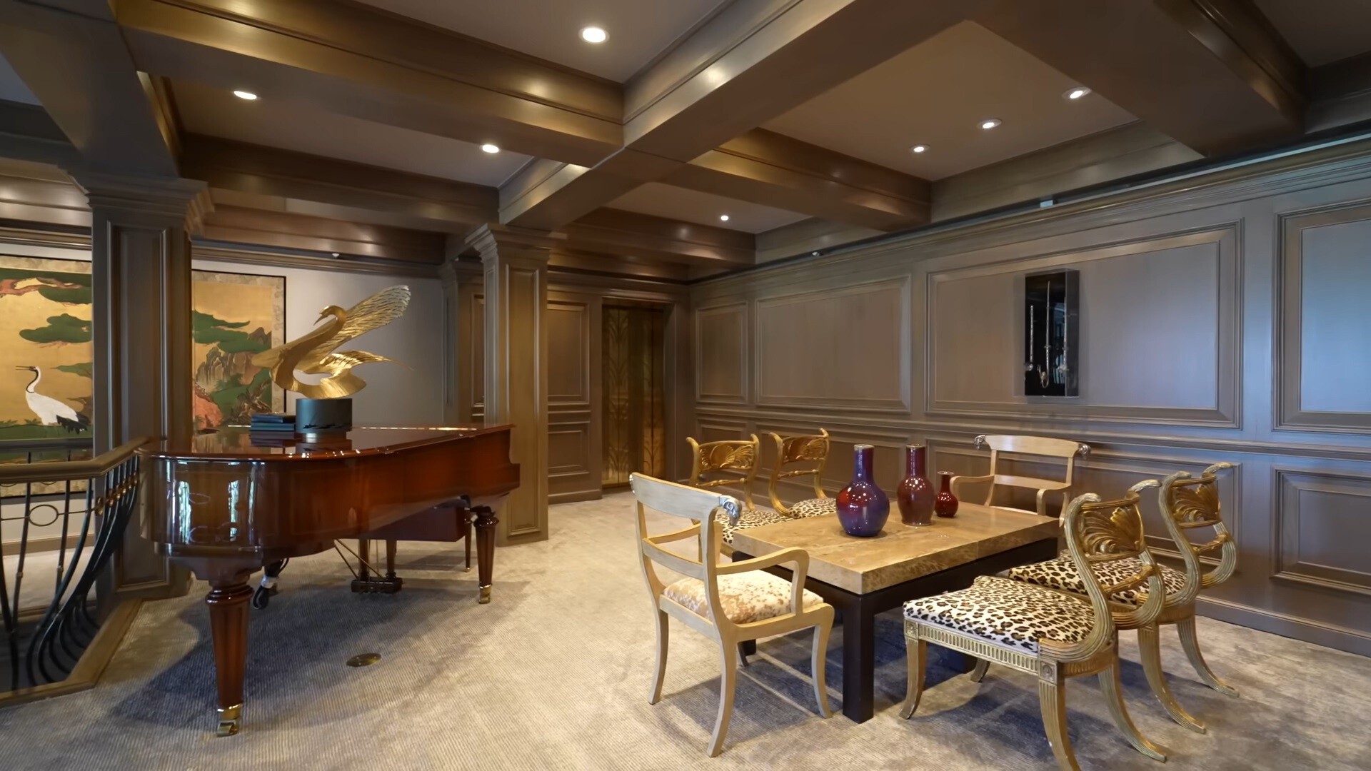 piano and a dining table with chairs on a balcony inside of the house