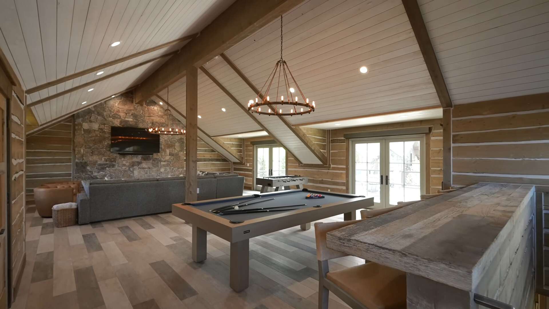 room with a bar, pool table and a soccer table